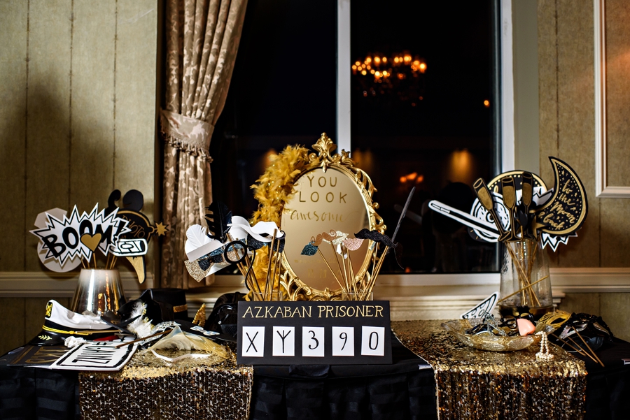 A table of handmaid gold photo booth props.